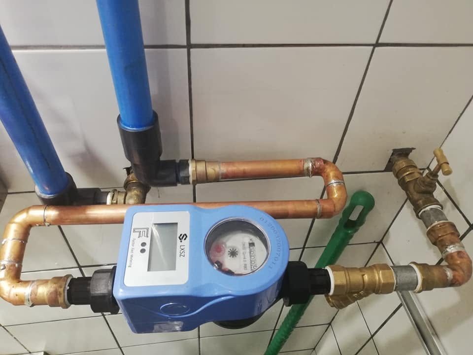 A FactorFast prepaid smart water meter installed with neat copper pipework